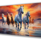 Canvas painting of seven running horses in white and brown with a yellow and orange sky background. Perfect for living room decor, this vibrant wall art also functions as a vastu painting